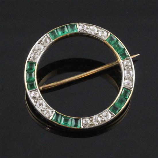 A gold, emerald and diamond open circle brooch, 1in.